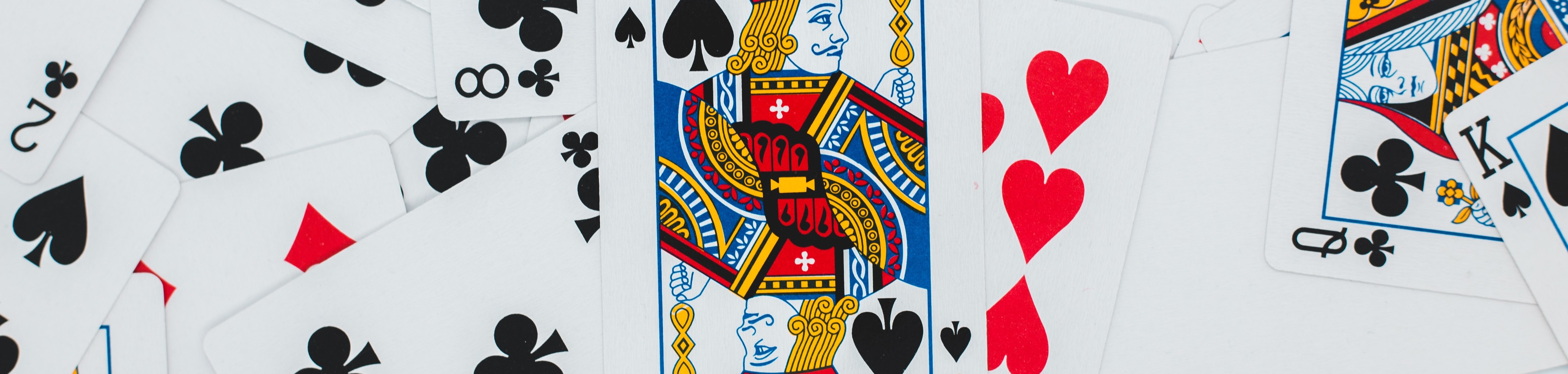 Playing cards with a king of spades as the center card.